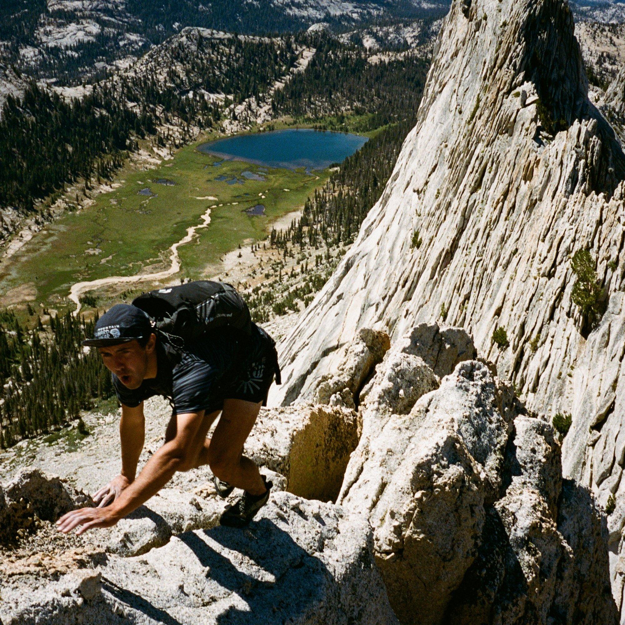 Professional mountain athlete Clayton Herrmann hoots as he uses his hands to help him balance while clambering.