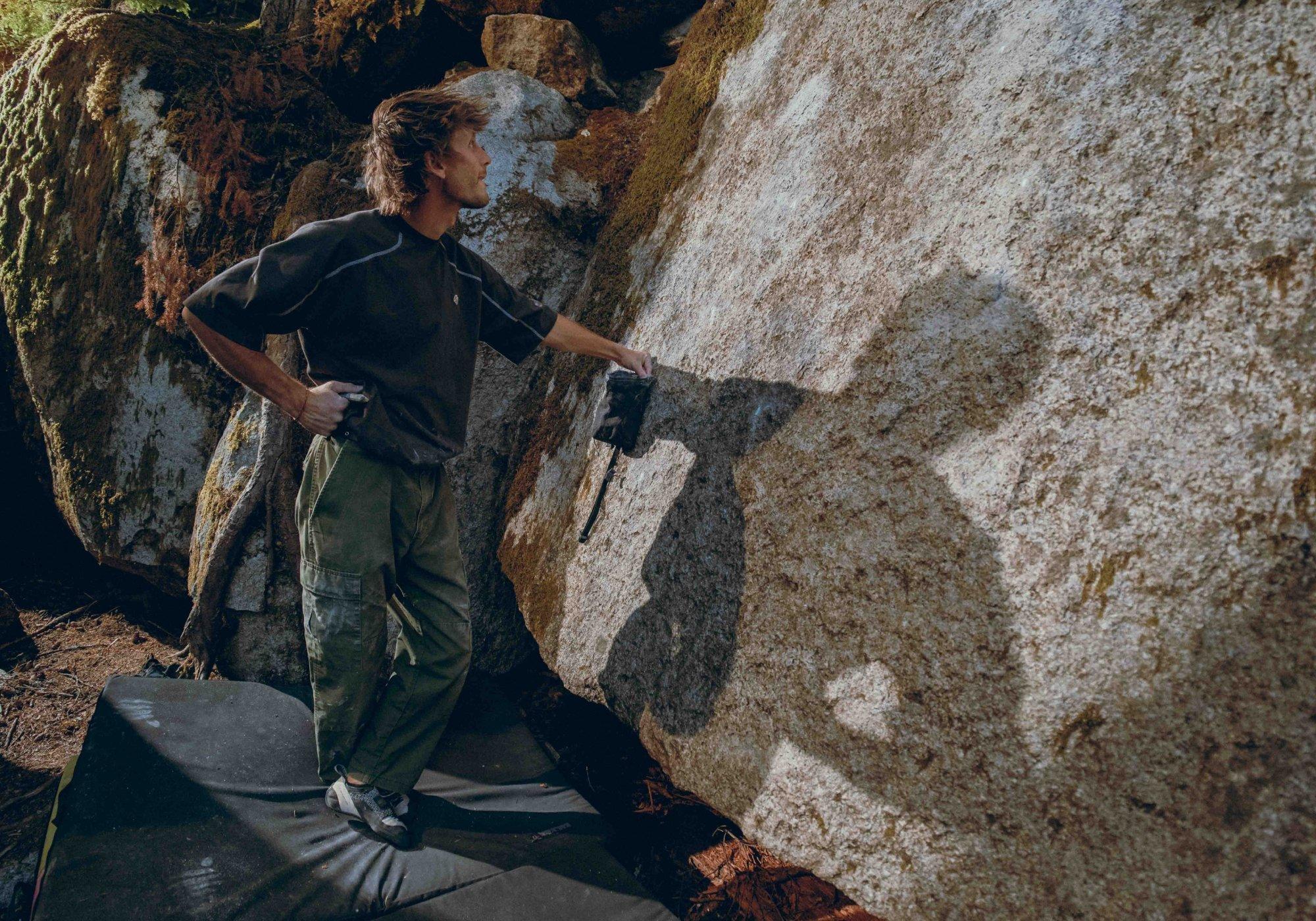 Seated on crash pads in chalk handprint-laden Rockrydge™ Pants, two climbers share an end-of-day laugh.