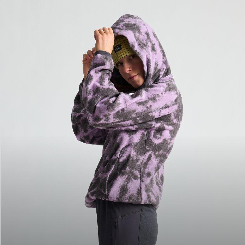 A woman carefully pulls the hood of her Microchill™ Hoody over her beanie. On screen text reads: Microchill™