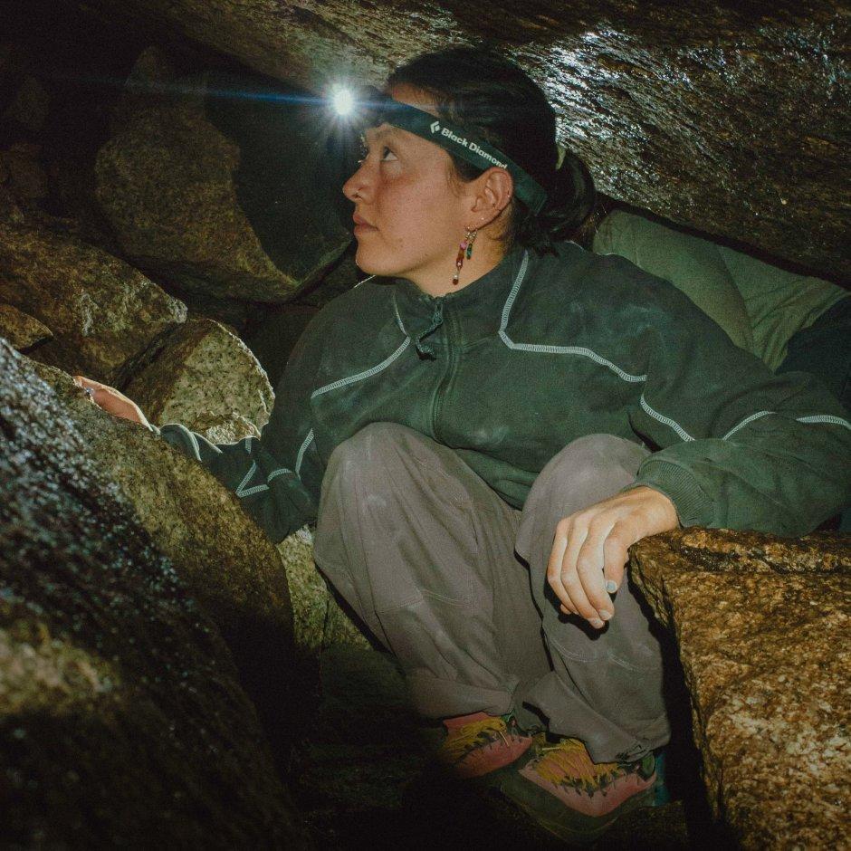 In a Hardwear Supply™  ¼ Zip, MHW Athlete Rell Lennox wedges between boulders. On screen text reads: Hardwear Supply™

